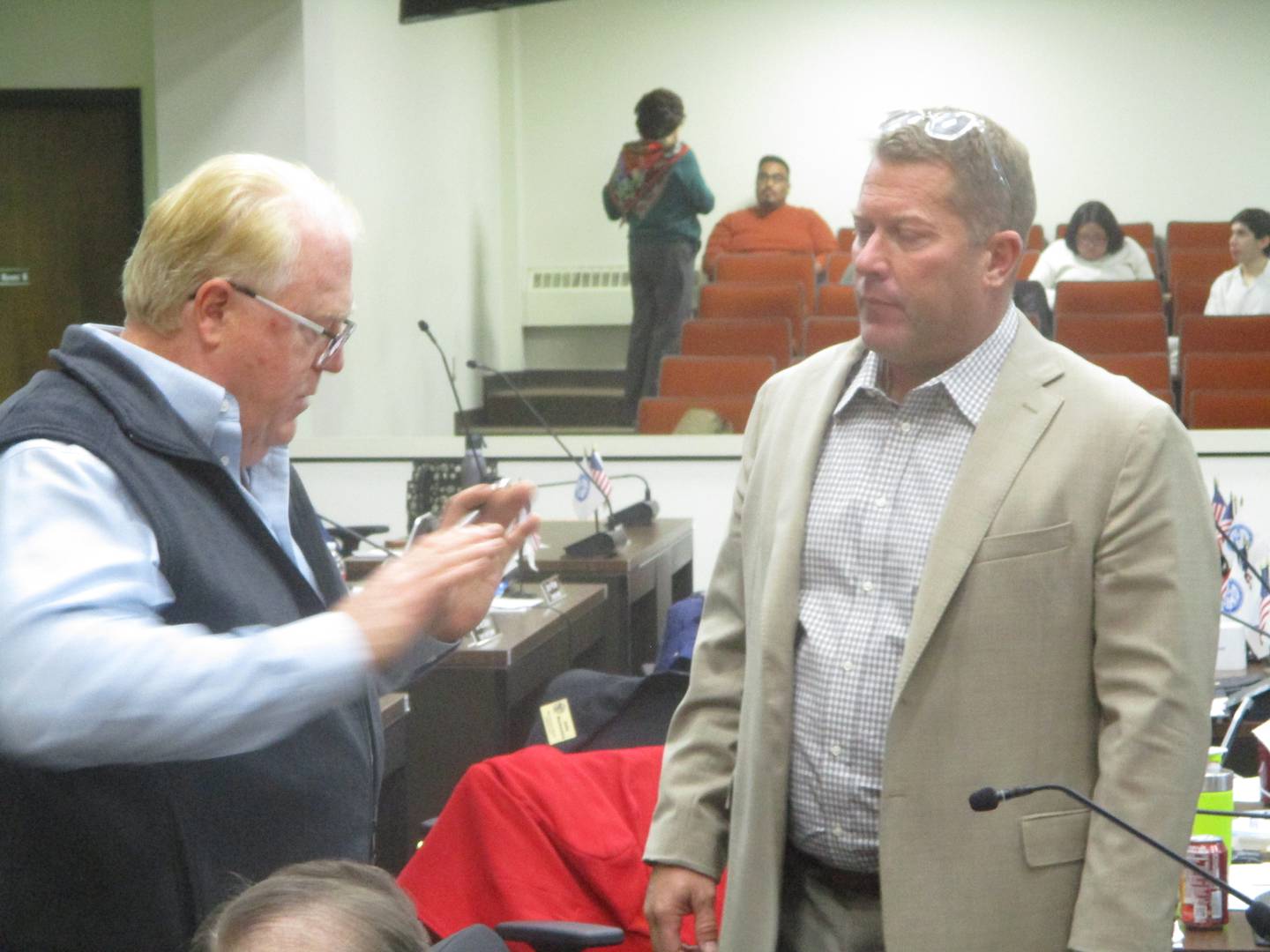 Will County Board Republican Leader Jim Richmond, R-Mokena, talks with board Speaker Joe VanDuyne, D-Wilmington, during a break at the Thursday meeting of the county board. Nov. 20, 2025
