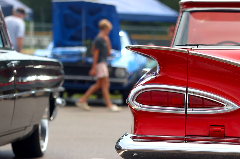 People look at classic cars during Fiesta Days at Petersen Park in McHenry Sunday.