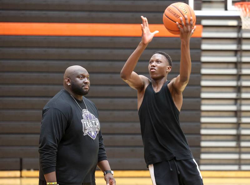 Jay Moore, founder of TRUTH Basketball Academy and an assistant basketball coach at DeKalb High School, watches DeKalb sophomore Gabe Crump, 15, work in a drill Tuesday, June 25, 2024, during a session at the school.