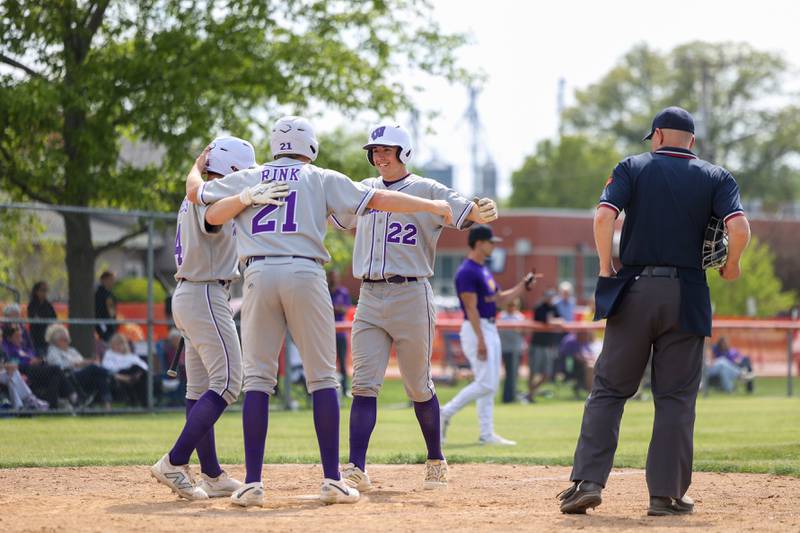 Wilmington's Ryan Kettman, right, celebrates with teammates Lucas Rink (21) and Dierks Geiss, as he scores a run following a two-run homer during the Wildcats 7-2 victory over Chicago Christian in the IHSA Class 2A Beecher Sectional semifinal on Thursday, May 29, 2025.