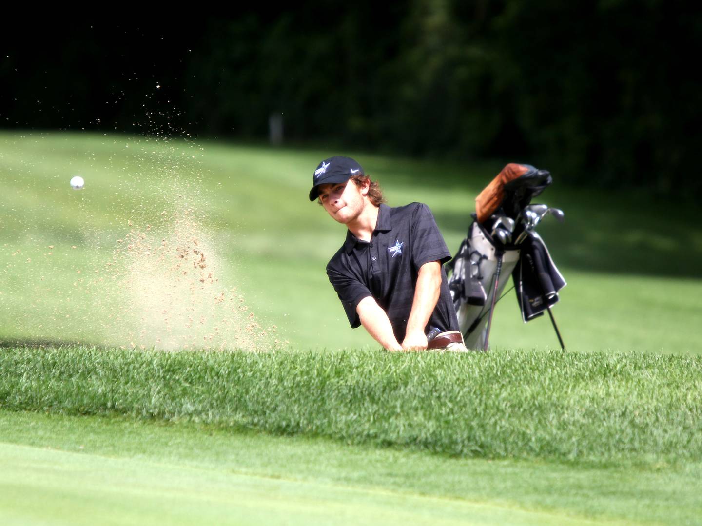 St. Charles North’s Clay Heilman hits out of the sand during the McChesney Cup golf tournament at the Geneva Golf Club on Monday, Aug. 15, 2022.