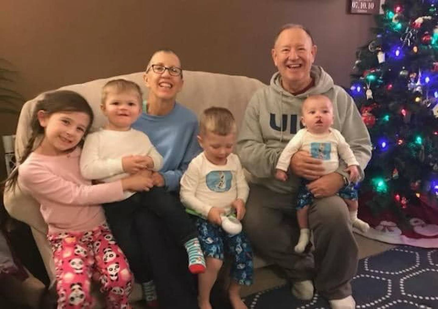 Timbers of Shorewoodv volunteer Joni Hilger and her husband Tom Hilger are seen with grandchildren Caleb, Blake, Kayden and Ryleigh near the Christmas tree.