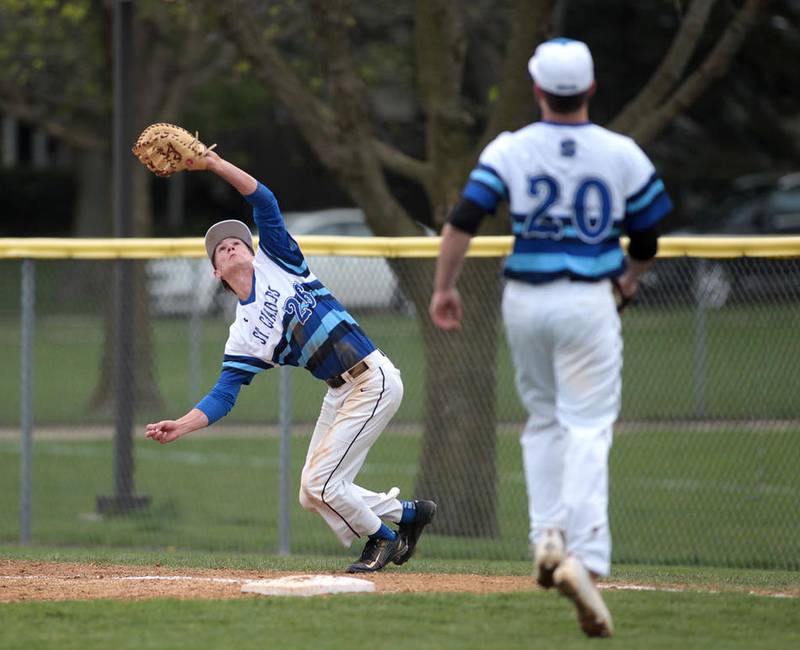St. Charles North first baseman Luke Corcoran (26) grabs a pop fly during the North Stars' 4-1 win at Geneva on April 28.