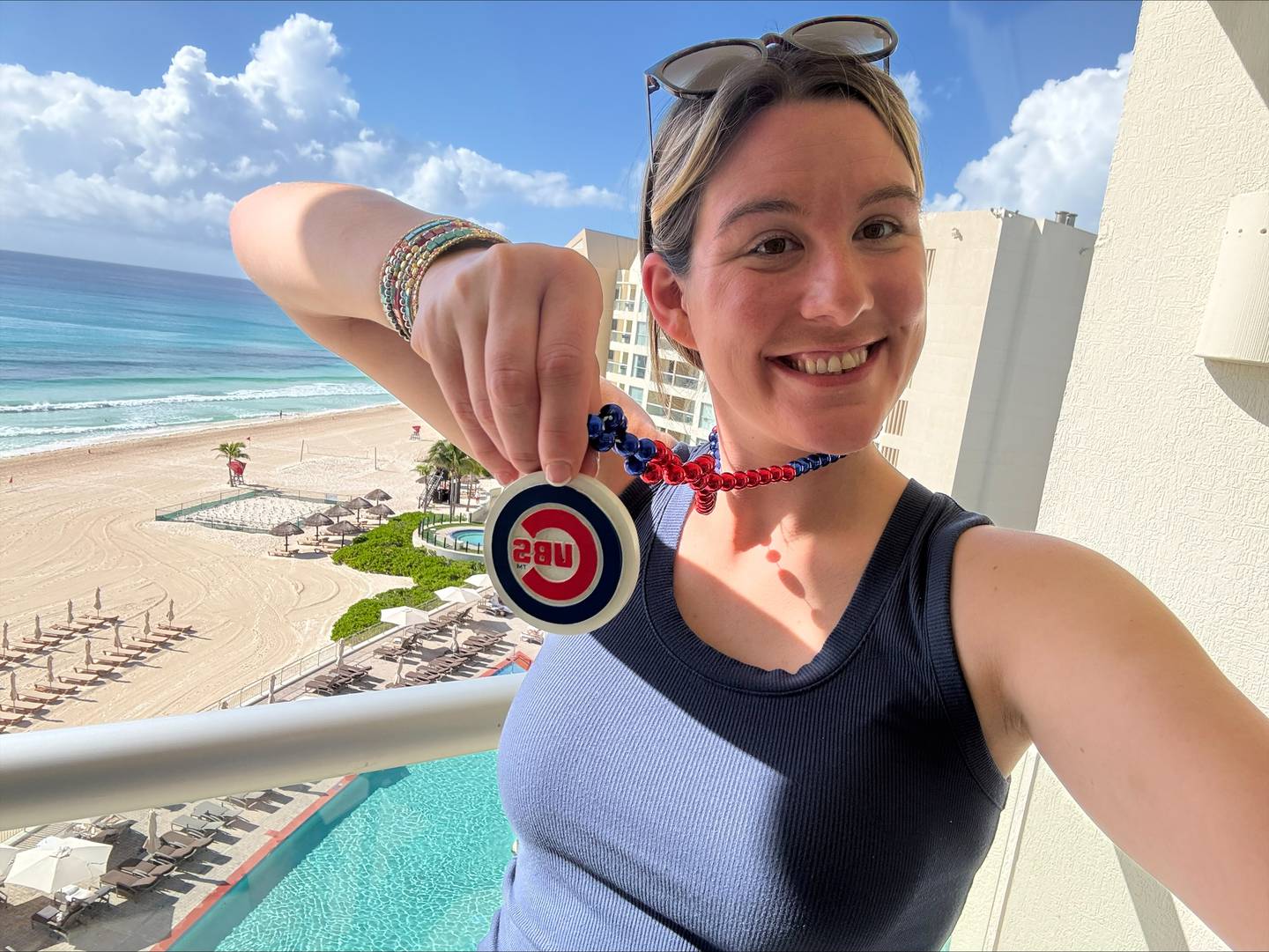 Bridgett Kolls, 29, happily expresses her Chicago Cubs fandom while on vacation in Cancun, Mexico, in 2025.