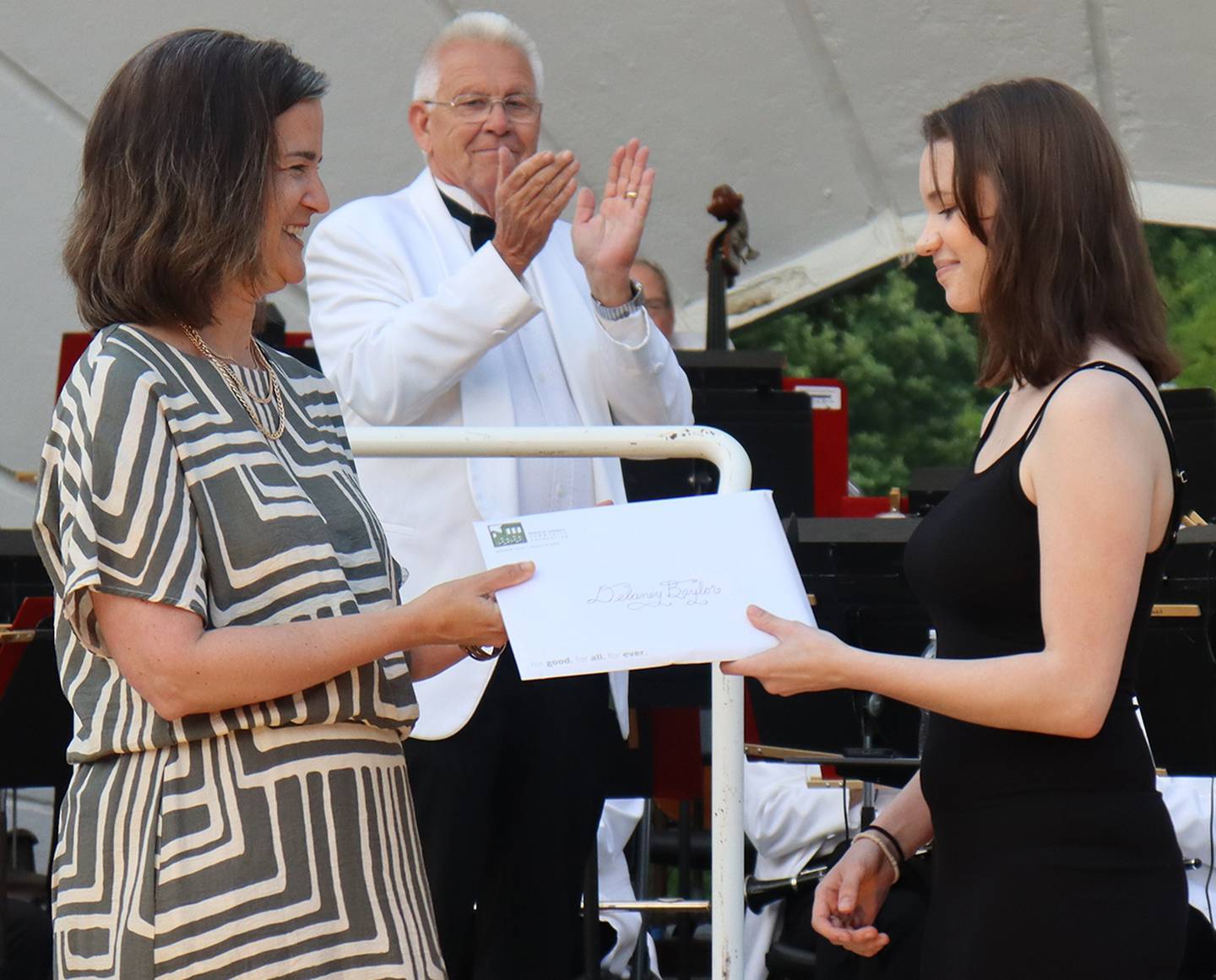 Delaney Baylor receiving a scholarship award certificate