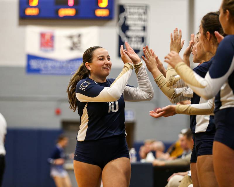 IC Catholic Prep's Natalie Lawton (10) is greeted by teammates during volleyball match between Nazareth at IC Catholic Prep.  Aug 29, 2023.