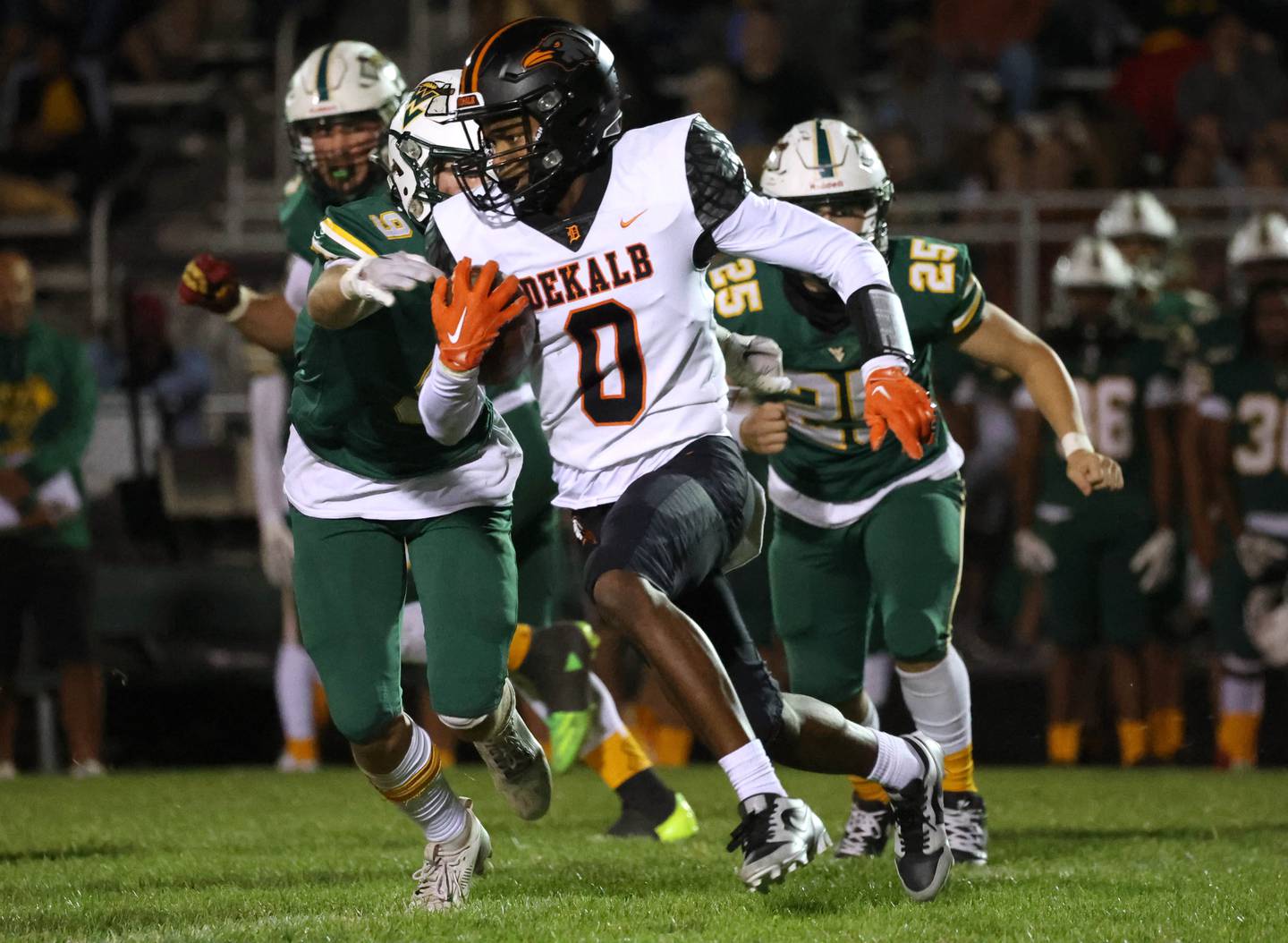 DeKalb's Billy Miller tries to get outside of the Waubonsie Valley defense during their game Friday, Oct. 11, 2024, at Waubonsie Valley High School in Aurora.