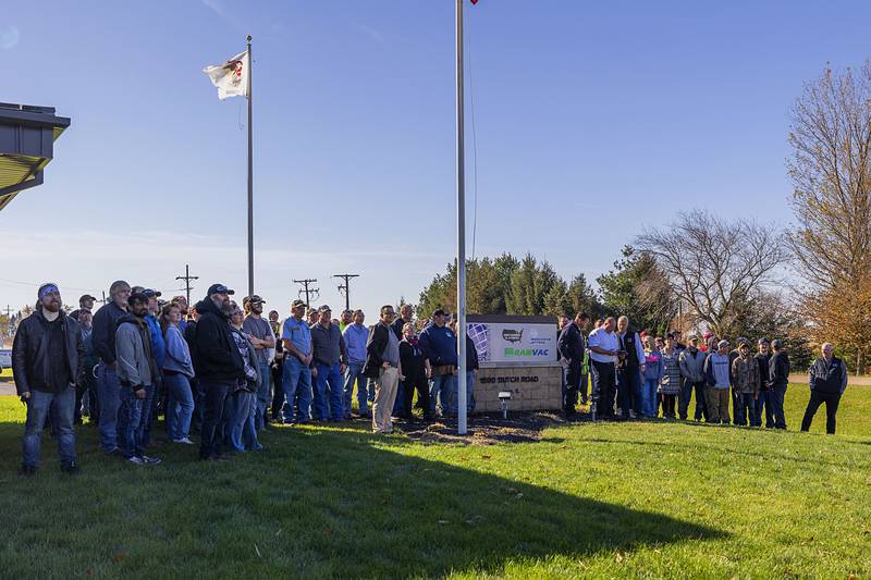 The group gathers near the sign to have a photo taken with the drone at the end of the demonstration.