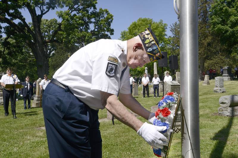 Ralph Stahl, a member of the Oswego American Legion Post 675, lays a wreath during the annual Memorial Day Parade and Service, Monday, May 29, 2023.
