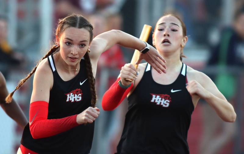 Huntley’s Emily Byers, right, hands off to teammate Reagan Ellis in the 800-meter relay in IHSA Class 3A Girls Sectional Track and Field Meet action at Red Raider Stadium on the campus of Huntley High School in Huntley on Wednesday, May 14, 2025.