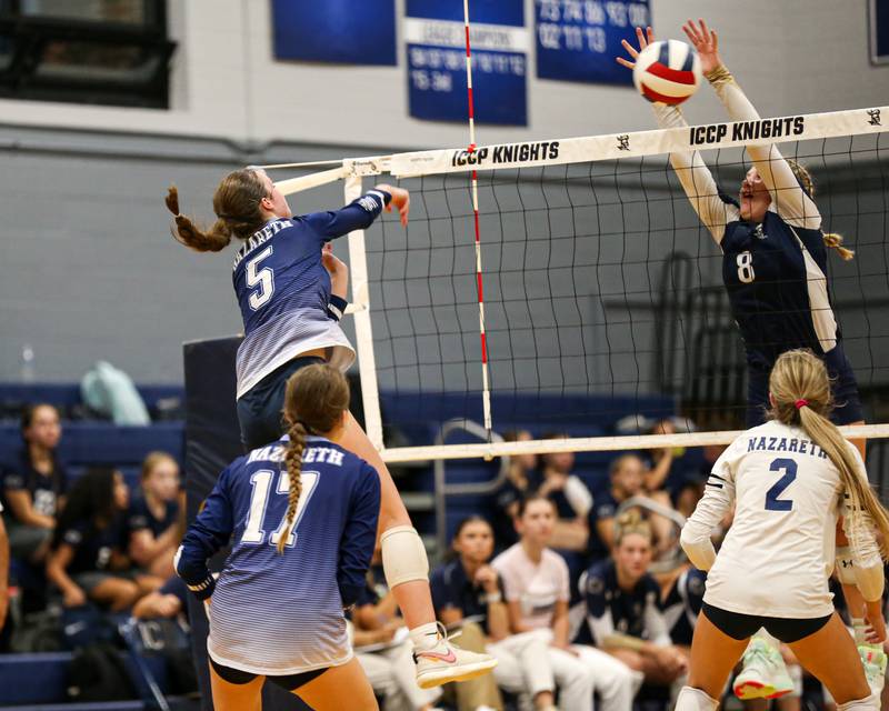 IC Catholic Prep's Lucy Russ (8) leaps high for block during volleyball match between Nazareth at IC Catholic Prep.  Aug 29, 2023.