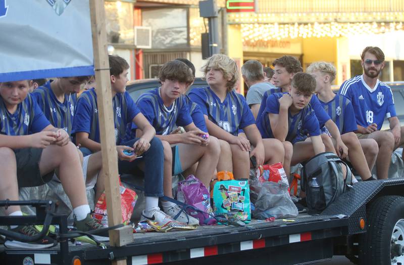 Members of the Princeton High School boys soccer team ride a float in the Homecoming parade on Thursday, Oct. 3, 2024 downtown Princeton.
