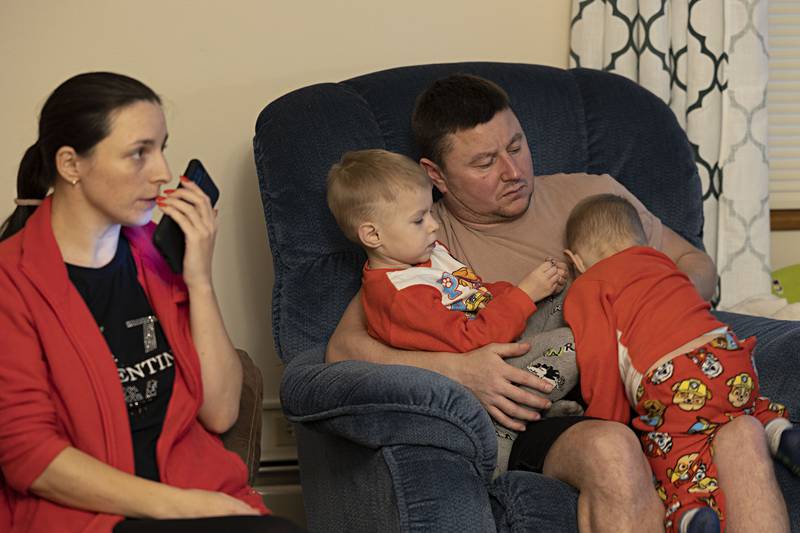 Oleg plays with his twin boys. Just a month after arriving, Oleg got a job as a welder Allied-Locke in Dixon.