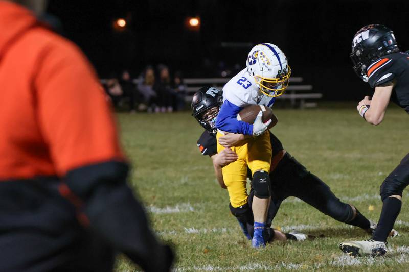 Alec Gustafson of Galva runs ball whilst being held down by Jaxon Flaut of Flanagan Cornell Woodland on Friday, October 25, 2024 at Flanagan High School in Flanagan.
