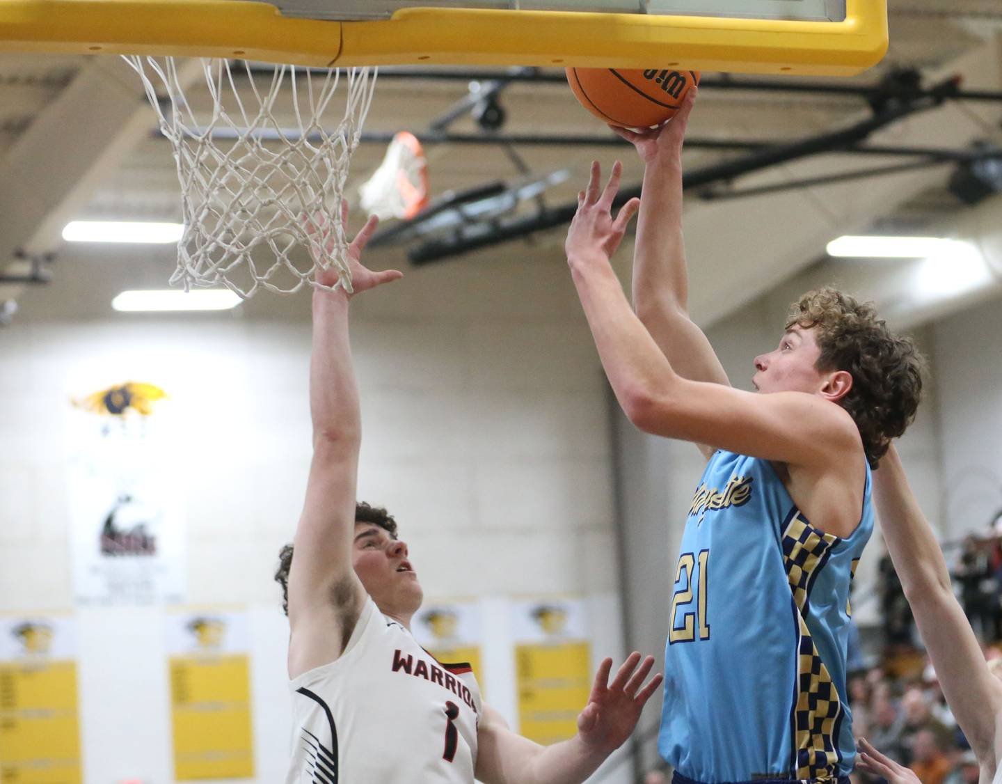 Marquette's Lucas Craig eyes the hoop as Woodland's Brezdyn Simons defends during the Tri-County Conference Tournament championship on Friday, Jan. 30, 2026 at Putnam County High School.