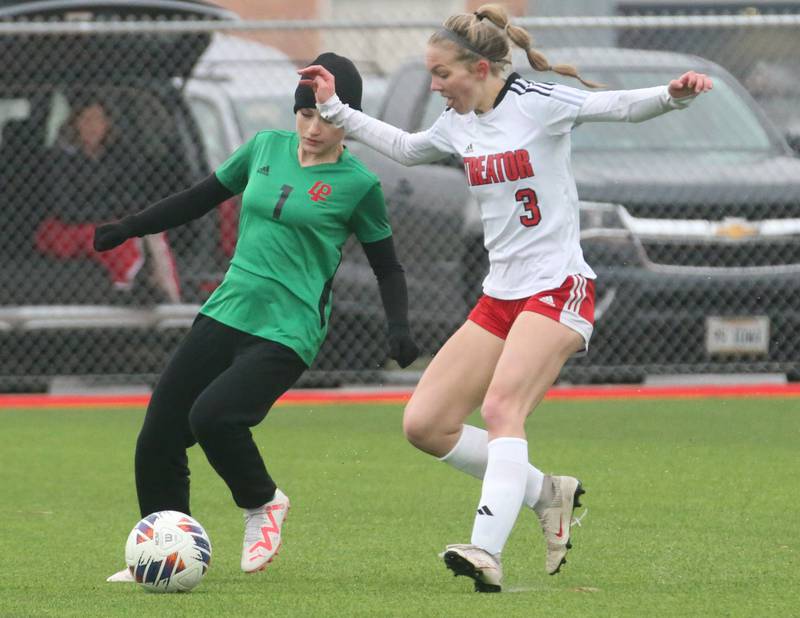 L-P's Addie Dawson pushes the ball away from Streator's Joey Puetz on Friday, March 22, 2024 at the L-P Athletic Complex in La Salle.