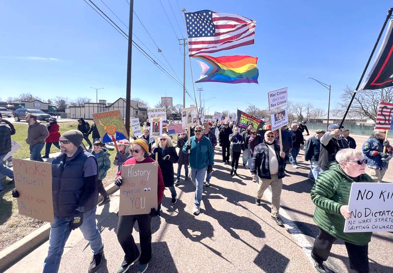 Protesters march north Saturday, March 28, 2026, on Sycamore Road in DeKalb during a No Kings march and rally against the federal actions of President Donald Trump and his administration.