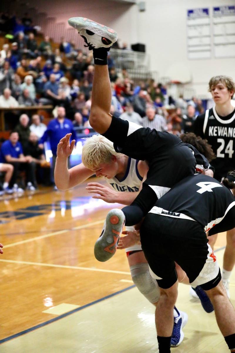 Kewanee's Catrelle Reed goes airbone as Princeton's Daniel Sousa ducks for cover Tuesday night at Prouty Gym.