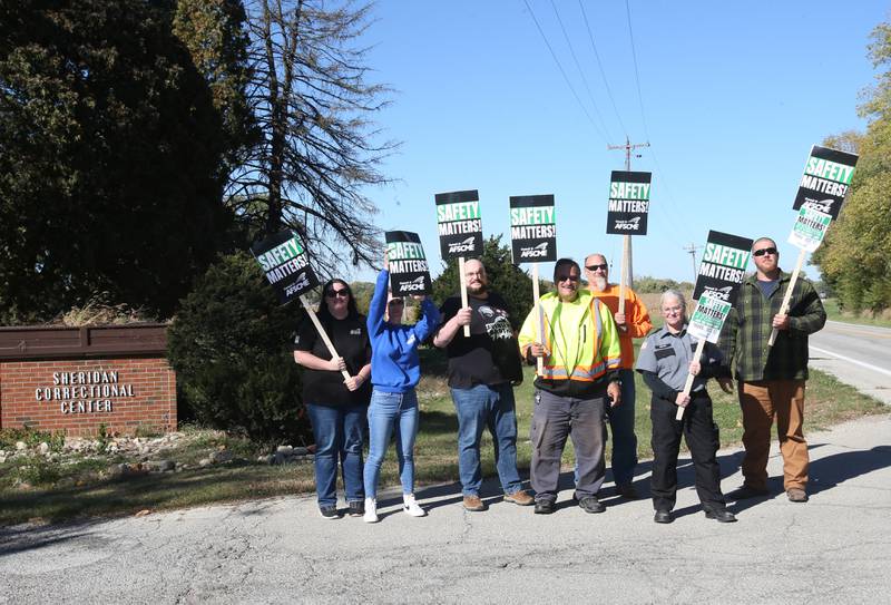 Sheridan Correctional Center employees hold signs saying "Safety matters, say 'no' to drug smuggling say 'no' to assaults on staff during a picket protest on Thursday, Oct. 17, 2024 outside the Sheridan Correctional Center in Sheridan.