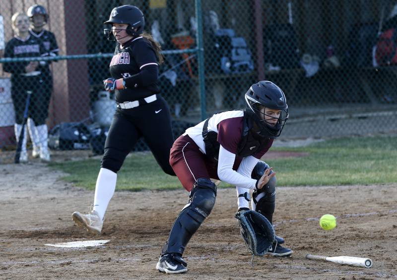Marengo's Kylee Jensen fields the ball as Antioch's Tanner Ludwig scores a run during a nonconference softball game on Monday, March 31, 2025, at Marengo High School.