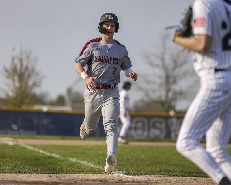 Plainfield North's Johnny Andretcih (2) trots into home for a run during baseball game between Plainfield North at Oswego East, Monday, April 28, 2025 in Oswego.