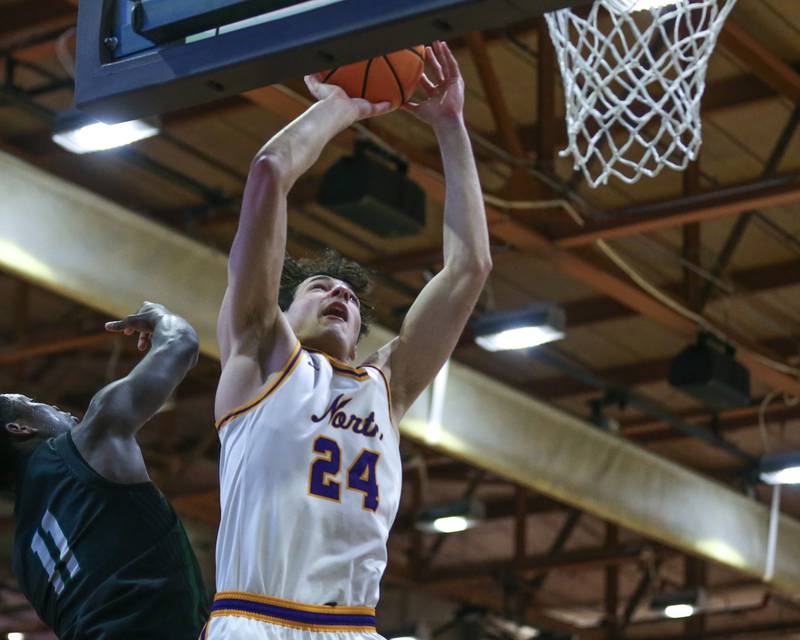 Downers Grove North's Aidan Akkawi (24) puts in a lay up during their basketball game between Glenbard West at Downers Grove North. Jan 24, 2025 in Downers Grove.