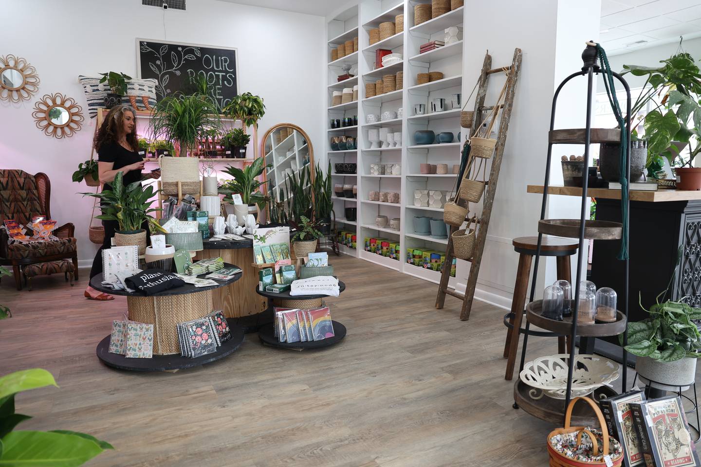 Michele Arana-Bianchi walks through her shop Internode Greenery and Home in Downtown Joliet on Thursday, April 20, 2023.