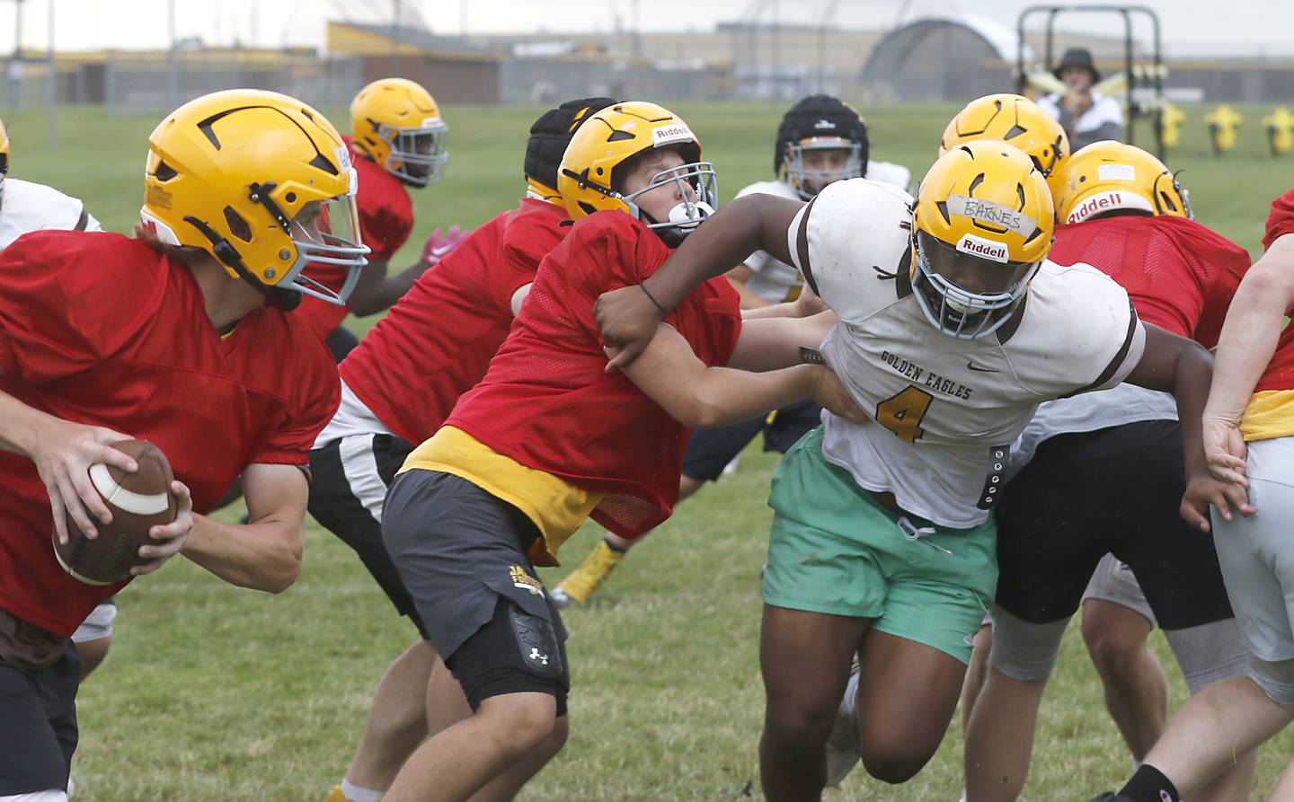 Jacobs’ PJ Barnes fights through a double  team block as she rushes the quarterback on Tuesday, July 2, 204, during a summer football Patrice at Jacobs High School.