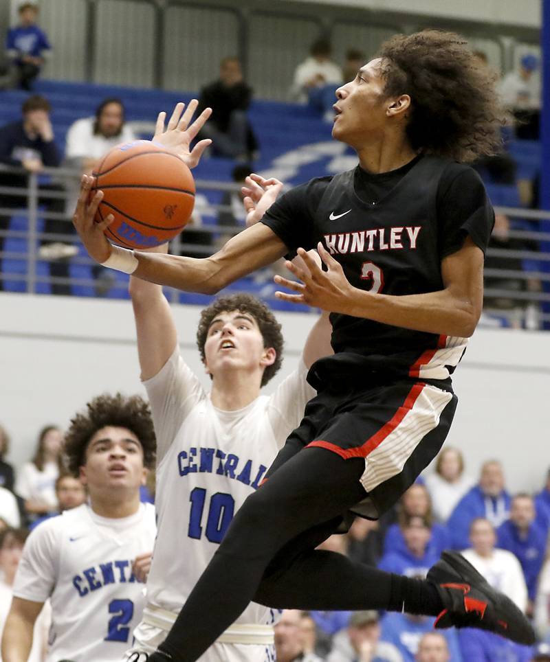 Huntley's Omare Segarra drives to the basket against Burlington Central's Myles Lowe during a Fox Valley Conference boys basketball game on Friday, Dec. 15, 2023, at Burlington Central High School.