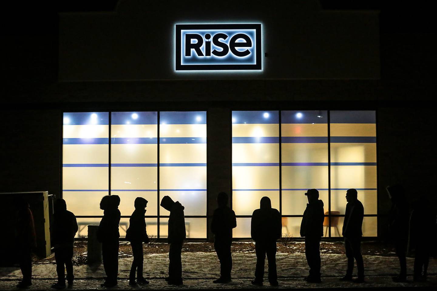 More than 100 people wait in line Wednesday, Jan. 1, 2020,  to legally purchase marijuana and marijuana-based products at Rise Joliet in Joliet, Ill.