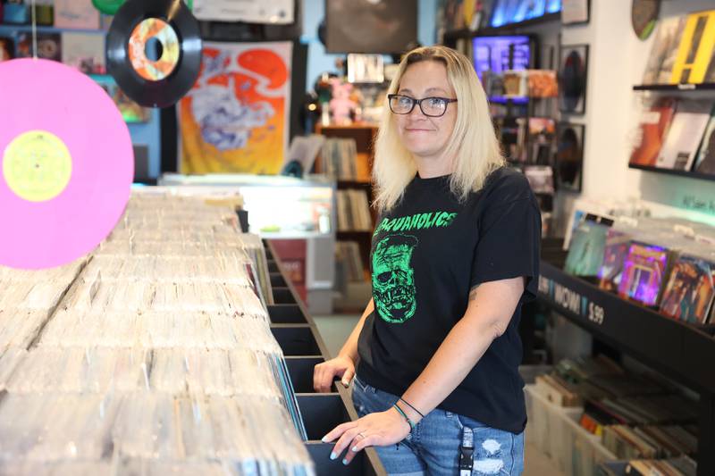 Tiffany Johnson, who owns Audiophil’s Records along with her husband Phil, stands in her shop in downtown Joliet. Friday, July 15, 2022 in Joliet.