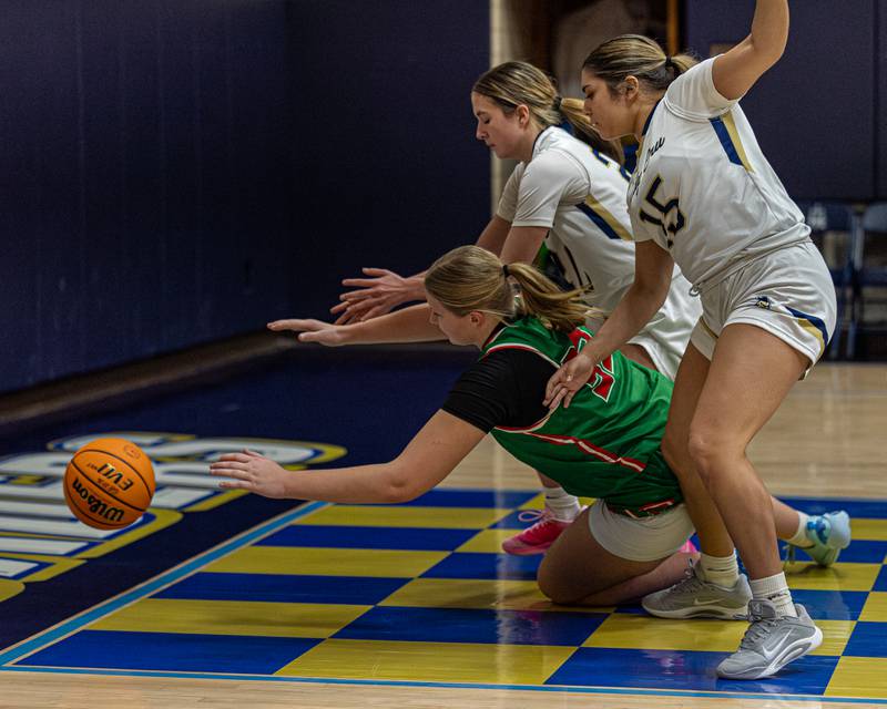Lily Morscheiser (33) of LaSalle-Peru dives for possession of ball before it falls out of bounds but is surrounded by Marquette's defense on Saturday, January 3, 2026 at Marquette Academy in Ottawa.
