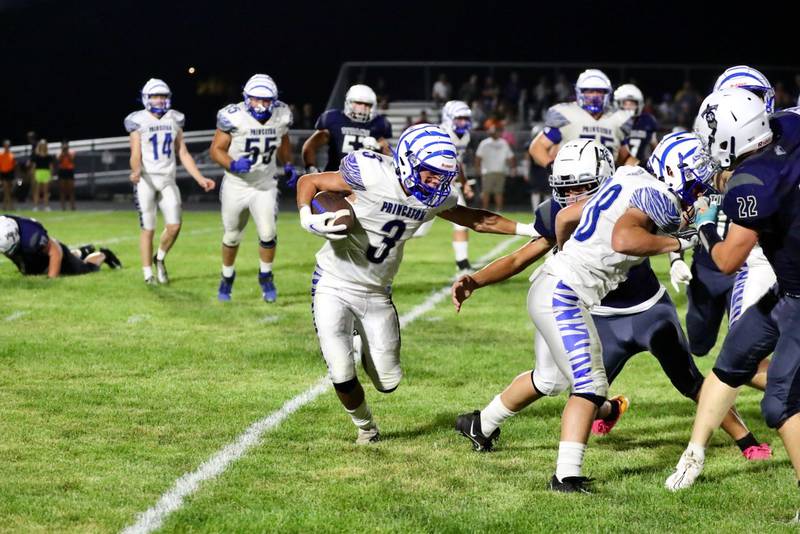 Princeton's Ace Christiansen uses a little stiff arm at Monmouth-Roseville Friday night. Princeton won 40-0.