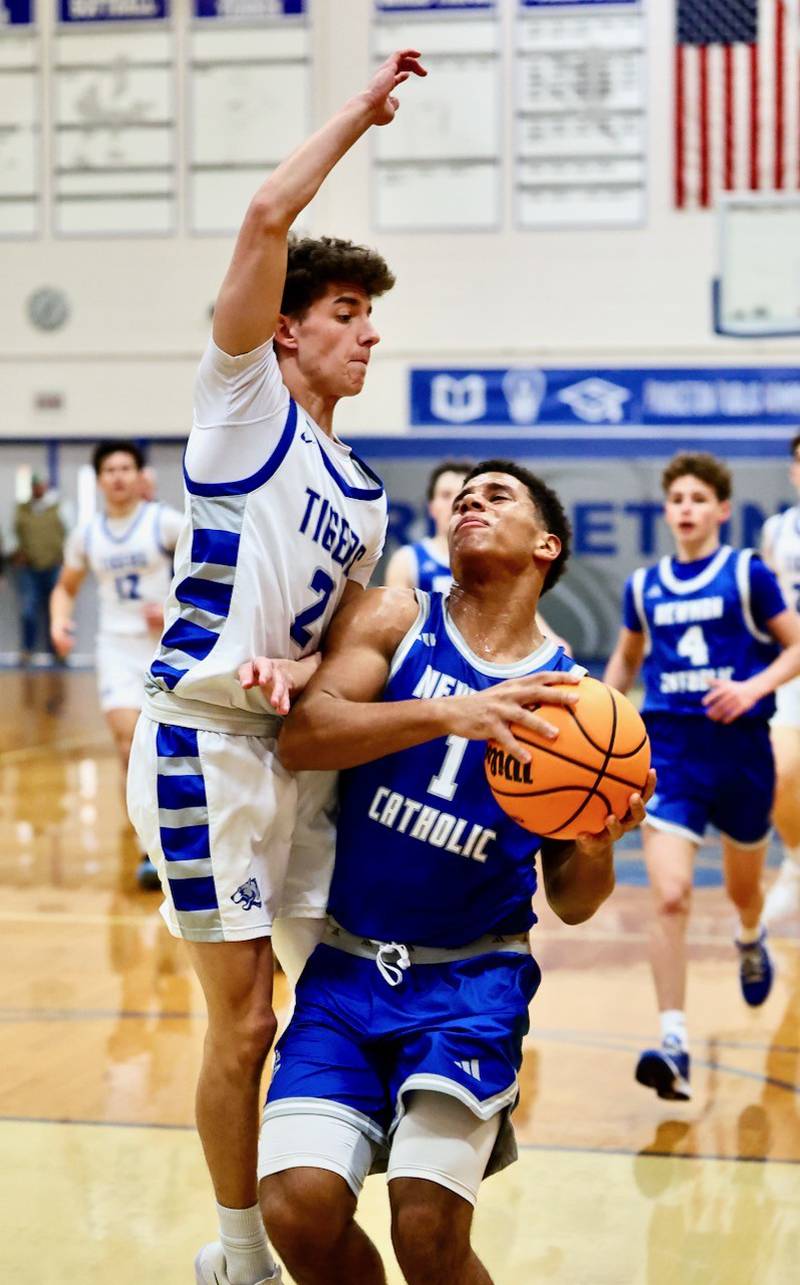 Princeton's Stihl Brokaw goes airborne on defense against Newman Saturday night at Prouty Gym.