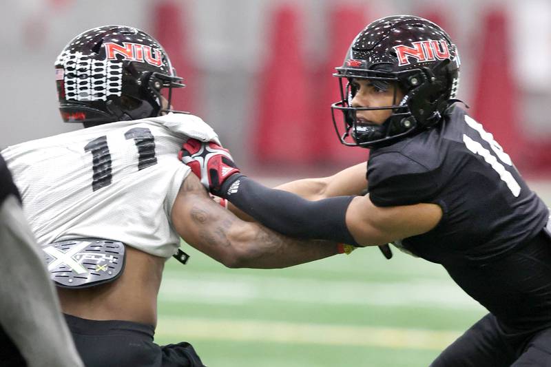 Northern Illinois University cornerback Jordan Gandy (right) fends off a block by receiver Messiah Travis during spring practice Wednesday, April 6, 2022, in the Chessick Practice Center at NIU in DeKalb.