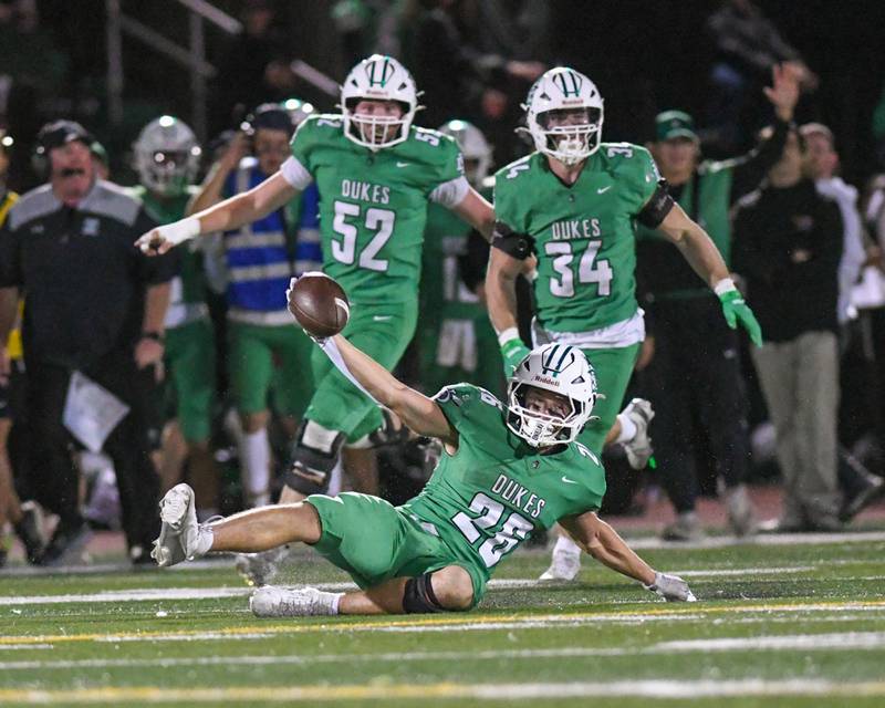 York's Henry Duda (26) slides in celebration as he gets the first down while securing a win over Glenbard West on Friday Oct. 17, 2025, held at York High School.