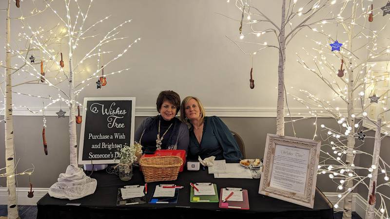 Shorewood HUGS members, from left, Celeste Bessette and Julie Adelmann, took a break from overseeing the wishes tree at the Shorewood HUGS annual chocolate ball fundraiser on Saturday, Feb. 3, 2024, at the Posh Banquets & Event Center in Joliet, to pose for a photo.  The fundraiser's theme this year was "Nashville Nights."