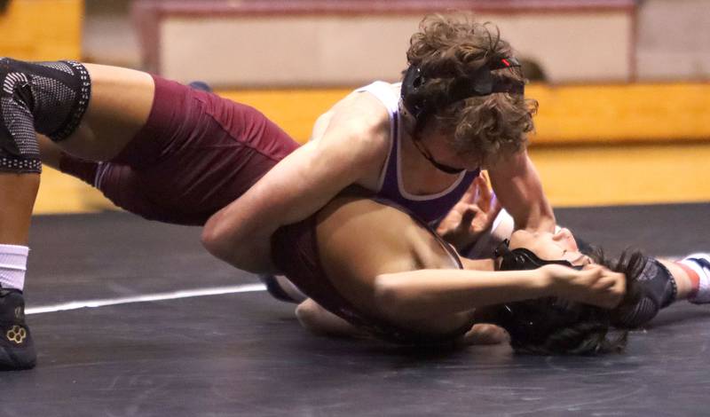 Prairie Ridge’s Yoni Bueno, bottom, battles Hampshire’s Andrew Salmieri at 120 pounds in varsity boys wrestling on Thursday, Dec. 4, 2025, at  Prairie Ridge High School in Crystal Lake.