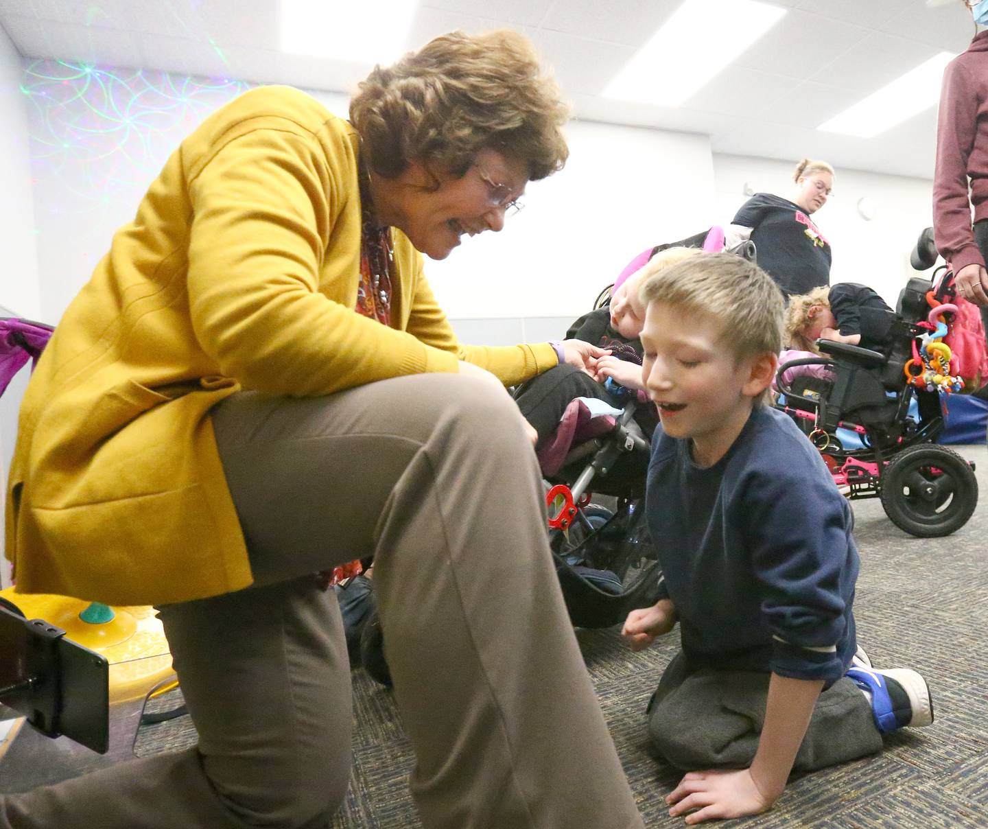 Jessica Kreiser, executive director of Lighted Way in La Salle, plays with student Kobey in a sensory room on Wednesday, April 20, 2022 at Lighted Way in La Salle. Lighted Way will be moving to a new location beginning the fall of 2023. The developmental center will occupy the former Heritage Health nursing home at 1445 Charters Street in La Salle.