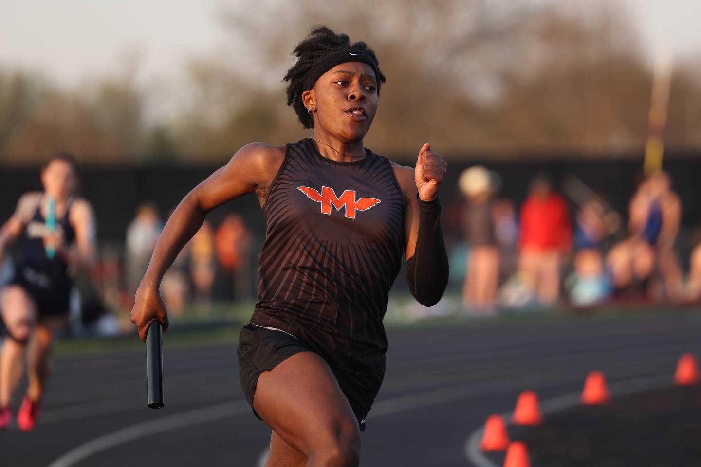 Minooka’s Elizabeth Egwunwoke rounds the final turn in the 4x200 relay at the Minooka Girls Track Invitational on Friday, April 14, 2023.