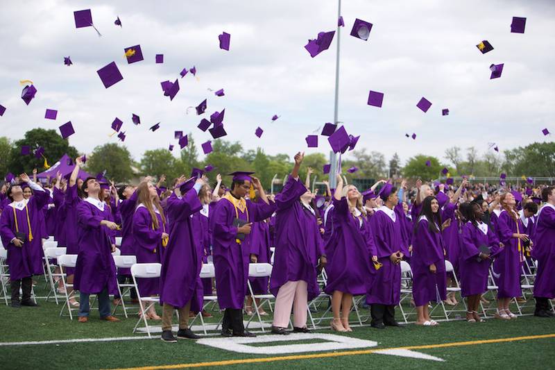 Downers Grove North graduates toss their caps in celebration at the Commencement Ceremony on Sunday, May 18, 2025 in Downers Grove.