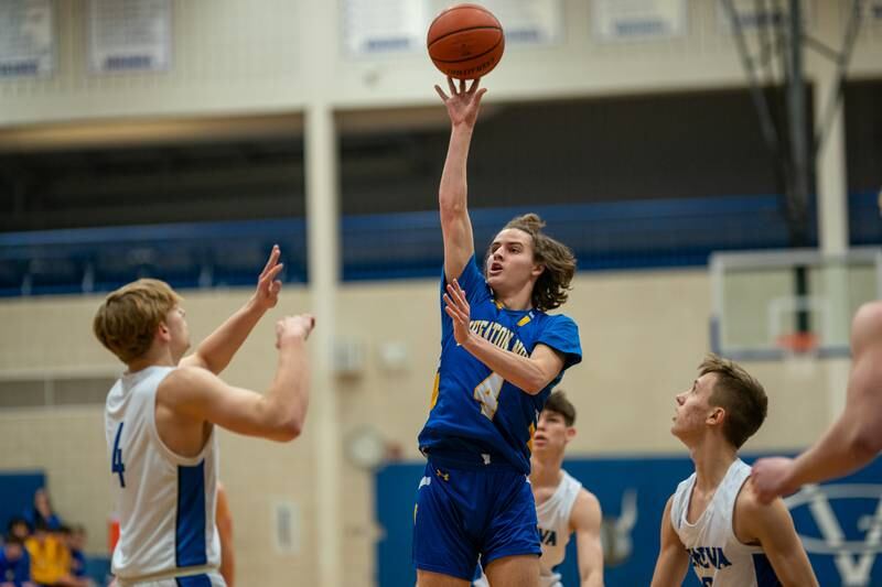 Wheaton North's Hudson Parker shoots a floater over Geneva’s Tanner Dixon during a basketball game at Geneva High School on Friday, Jan 6, 2023.