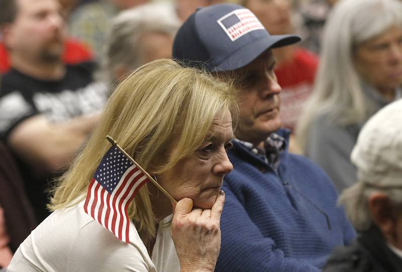 Cindy and Bruce Johnson listen to board members debate a resolution opposing the Illinois gun ban and supporting its repeal at the McHenry County Board meeting Tuesday, Feb. 21, 2023, in the McHenry County Administration Building.