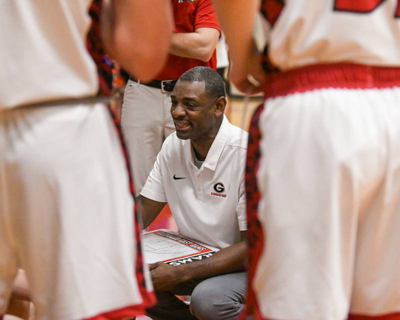 Glenbard East's head coach Eric Kelly talks to the team between quarters during the game on Friday Dec. 19, 2025, while taking on Riverside Brookfield held at Glenbard East High School.