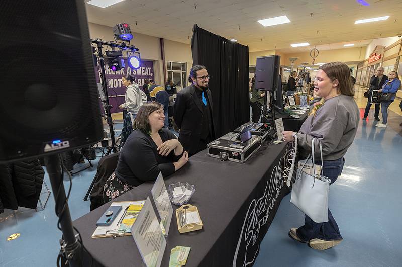 Brynn Nuckols (right) of Mt Morris, speaks with Rachel and Hector Rivera Sunday, Feb. 2, 2025, at the Sauk Valley Wedding Expo in Sterling. The Riveras run Cara Mia entertainment.