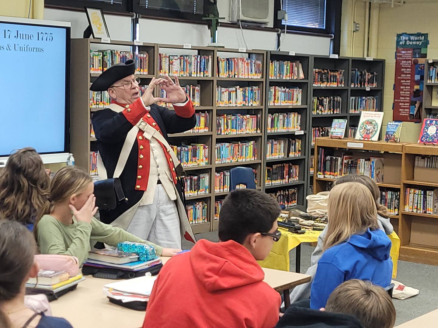 Dick Wells answers questions Wednesday, Dec. 20, 2023, from students at Logan Junior High School in Princeton regarding the Revolutionary War.