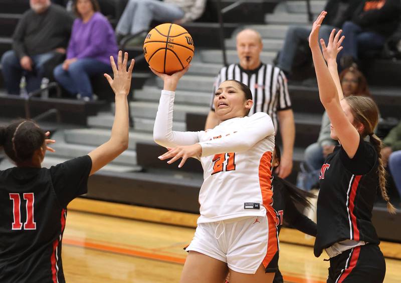 DeKalb's Alicia Johnson shoots between two Rockford East defenders during their game Wednesday, Jan. 22, 2025, at DeKalb High School.