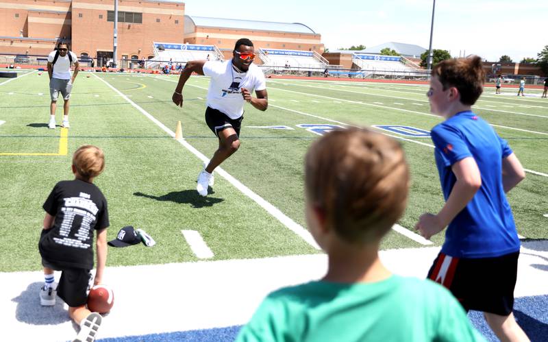 Former St. Charles North standout and current New York Giants defensive back Tyler Nubin runs a sprint while working with young players on the first day of a three-day football camp on Friday, June 20, 2025 in St. Charles.