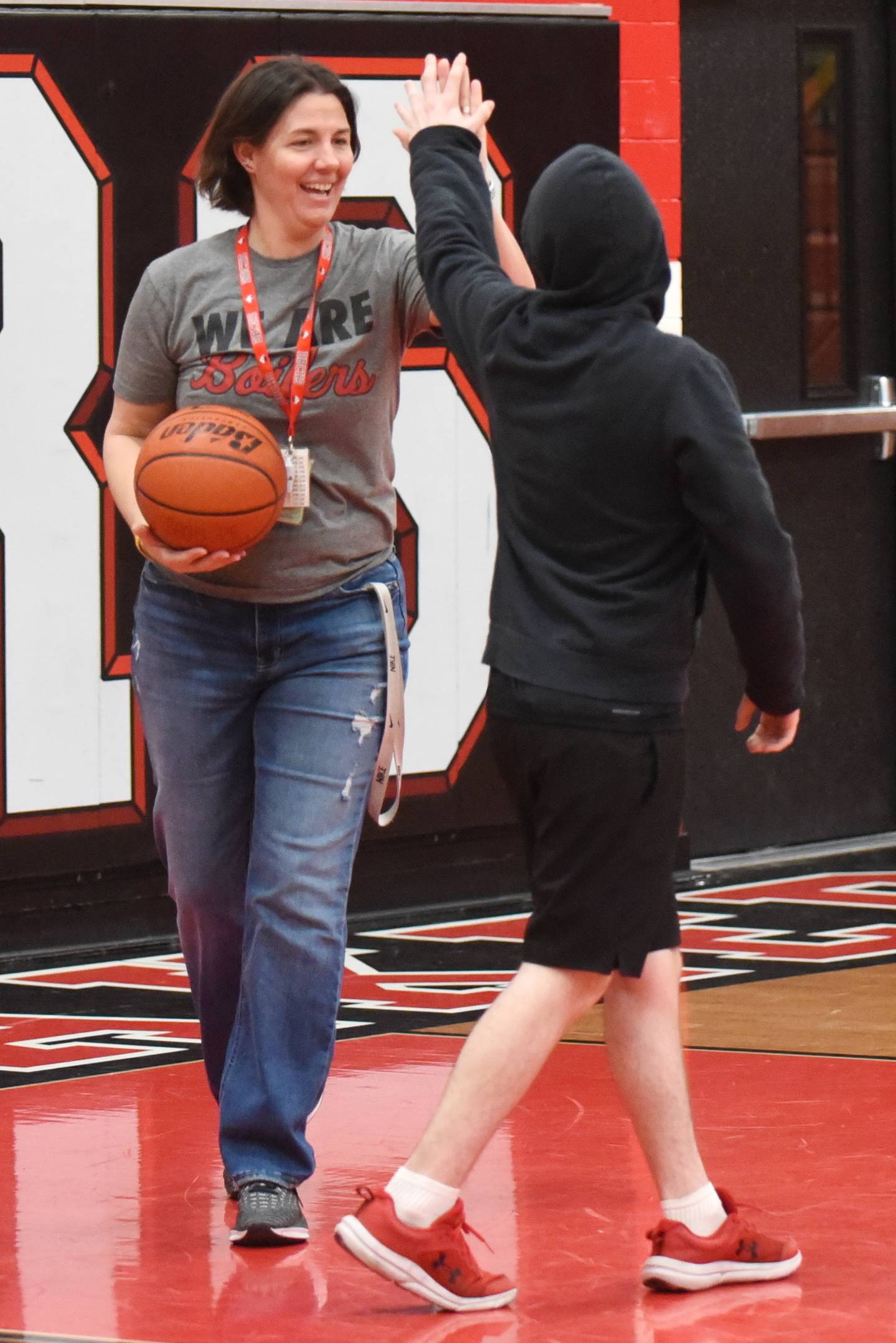 Bradley-Bourbonnais High School PE teacher Leigh Reiniche (left) high-fives adapted PE student Waylon Walsh during class Friday, April 4, 2025.