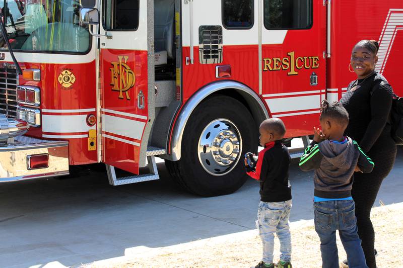 A family tours the fire trucks on display outside DeKalb Fire Station No. 4 at 1130 S. Malta Road at a grand opening event on Saturday, April 26, 2025.
